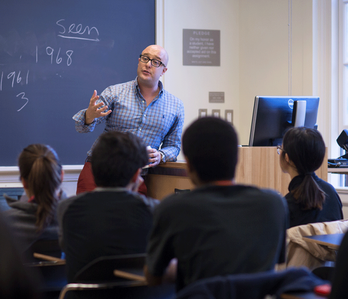 Professor Andre Cavalcante with student discussion