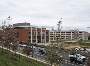 Cars and trucks pass new construction on Emmett street