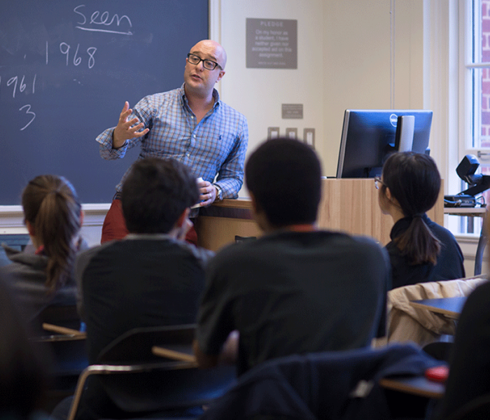Professor Andre Cavalcante in class with students