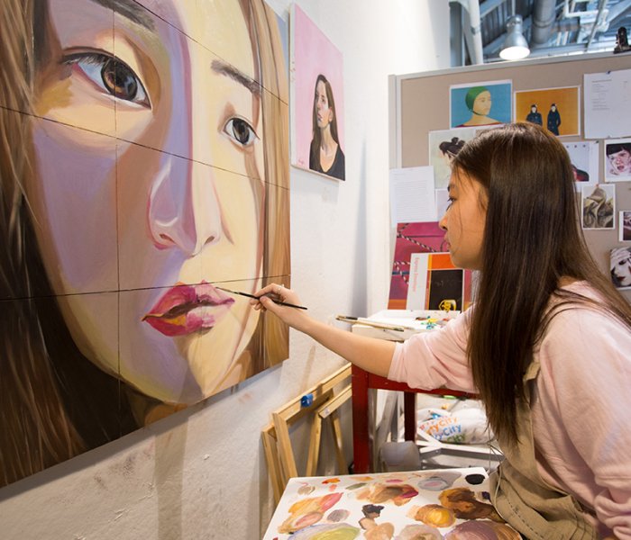 Female art student painting a portrait